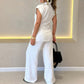 Elegant set med ärmlös blus och löst sittande byxor med hög midja